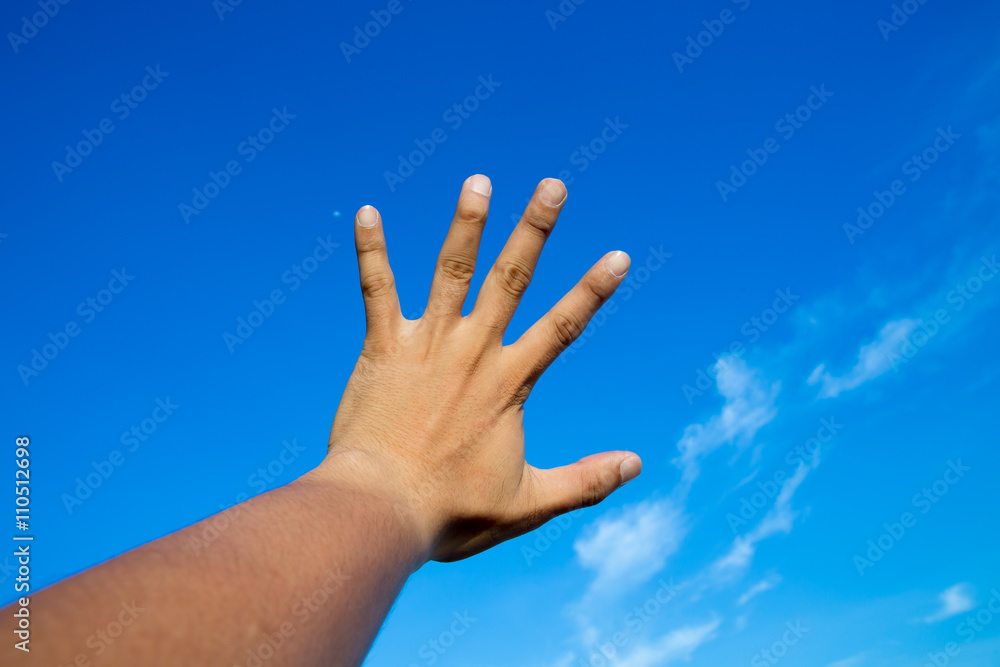 hand in blue sky