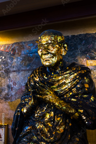 Statue covered in gold leaf at Temple of the Reclining Buddha Wa