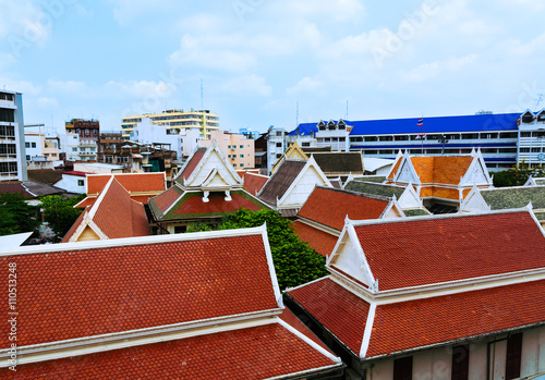 View of colorful oriental rooftops from Wat Traimit temple Bangk photo