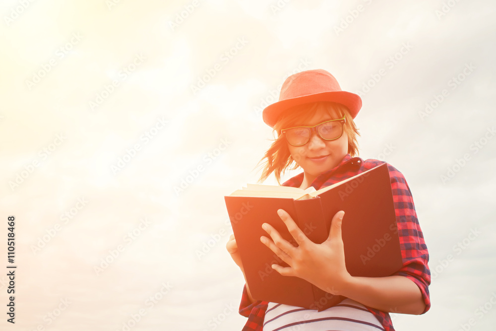 Young educated woman standing reading book