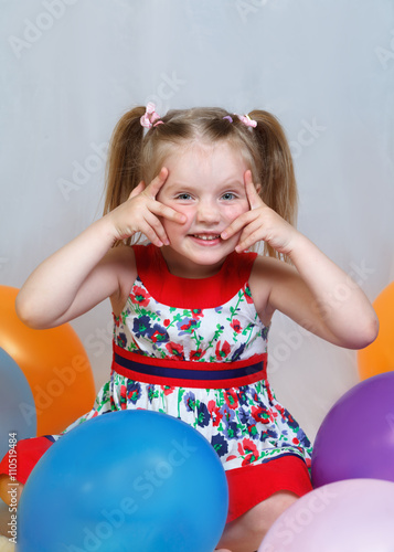 portrait of a little girl playing with balls
