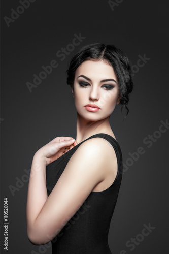Portrait of beautiful female model on gray background