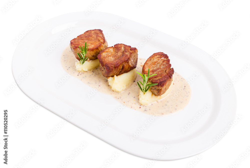 Fried pork tenderloin medallions on mashed potatoes. Fried pork tenderloin medallions on mashed potatoes.