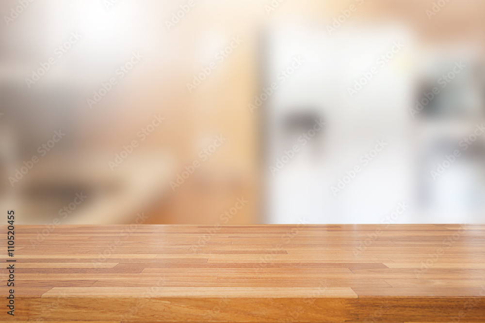 Empty wooden table and blurred kitchen background Empty wooden table and blurred kitchen background