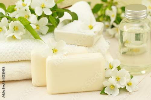 SPA setting. Jasmin soap and flowers and on wooden table