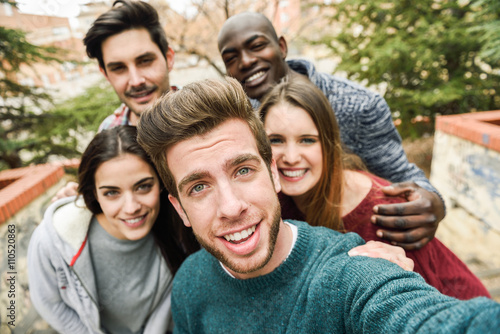 Multiracial group of friends taking selfie