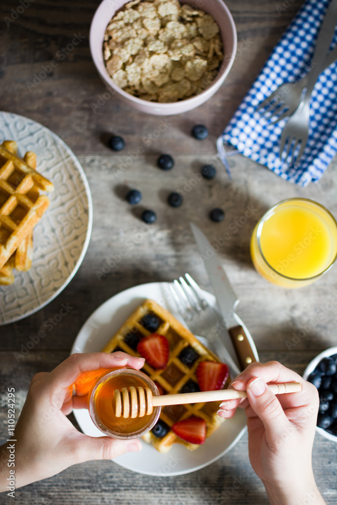 Delicious waffle with blueberries and strawberries honey Delicious waffle with blueberries and strawberries honey