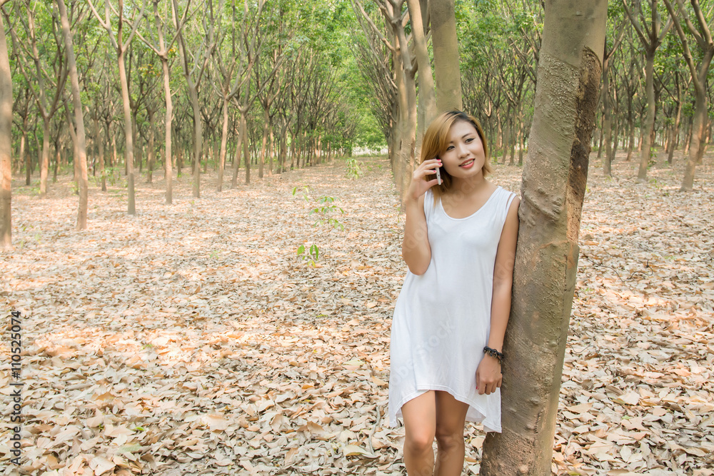 sexy beautiful woman using a smartphone in forest sexy beautiful woman using a smartphone in forest