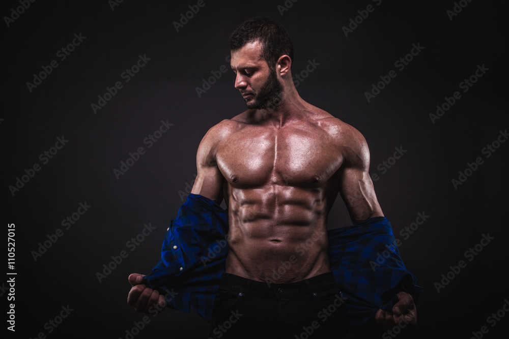 Fit and sexy man posing in studio.