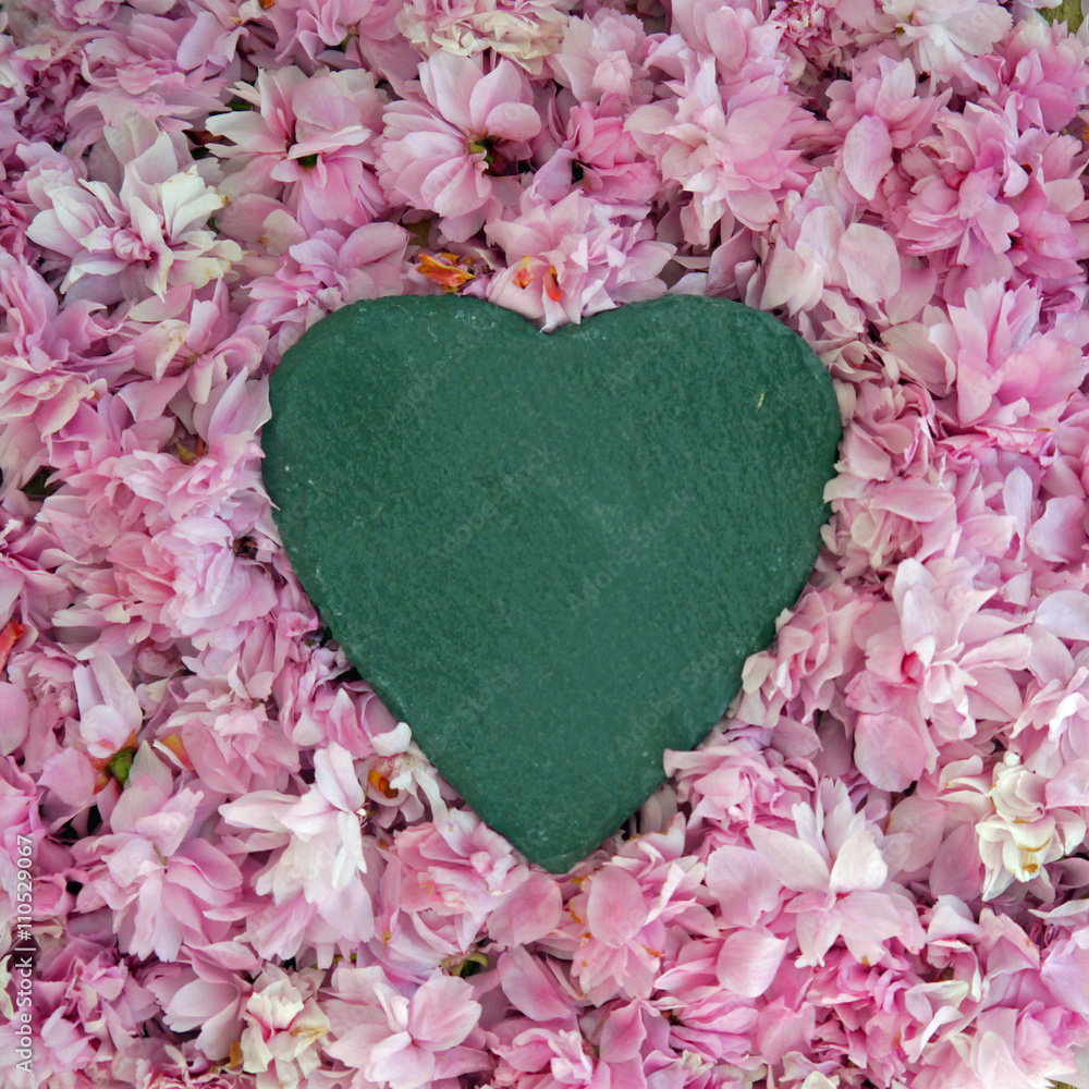 Black slate heart on a pink blossom background. Space for text Black slate heart on a pink blossom background. Space for text