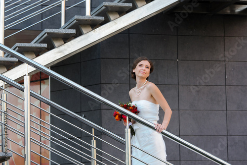 The bride in a beautiful modern metal staircase © lisovoy