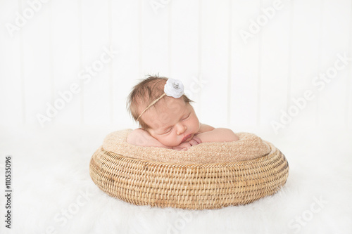 sleeping newborn baby in a basket