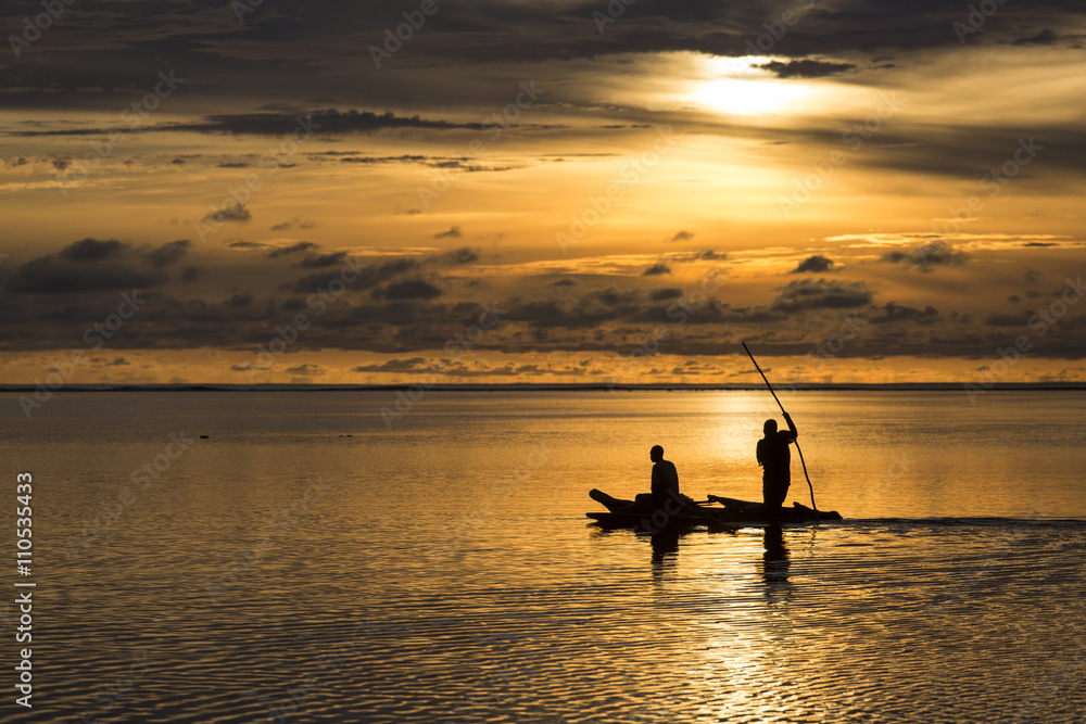 Fishermen going on ocean on traditional fishing boat in Zanzibar