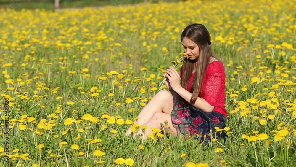 Model. Sitting among the blooming flowers of dandelion Model. Sitting among the blooming flowers of dandelion