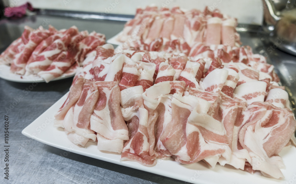 Numerous Strips of Raw Ham Pork Bacon Prepared for Cooking in a Restaurant Kitchen