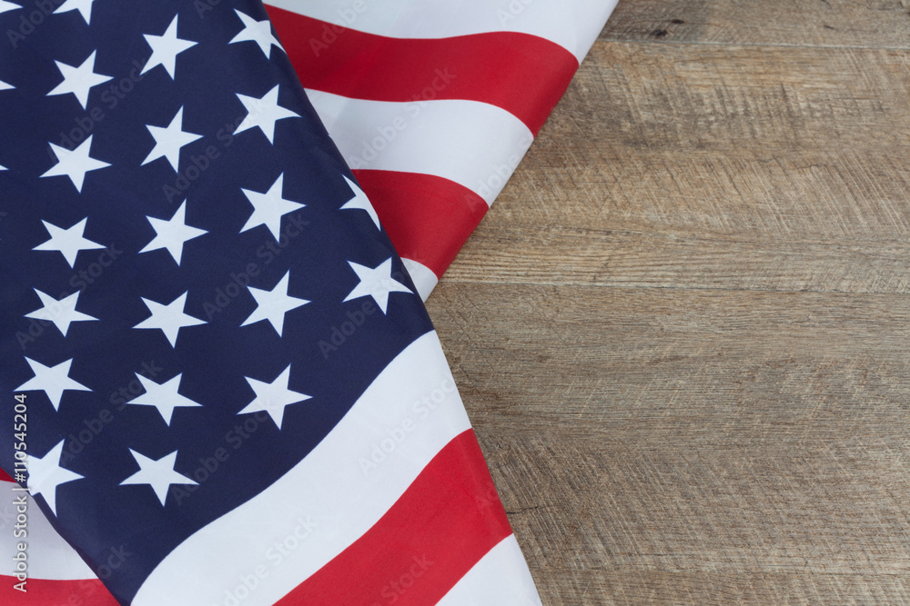 Obraz premium American flag folds on walnut wooden table. Horizontal image with copy space
