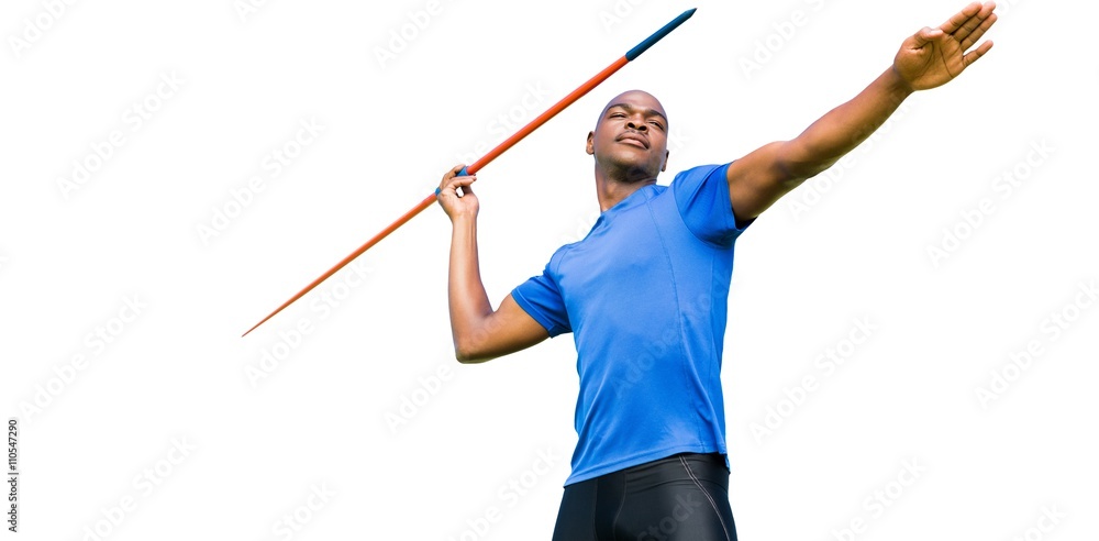 Concentrated sportsman practising javelin throw 