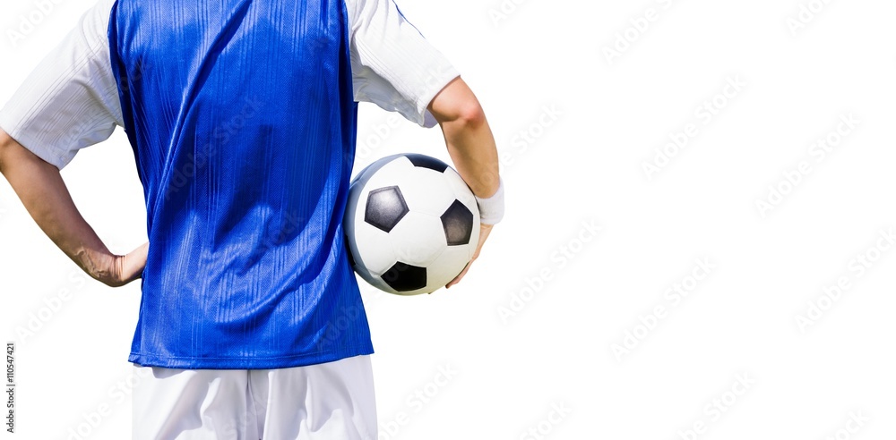 Rear view of football player holding a football 