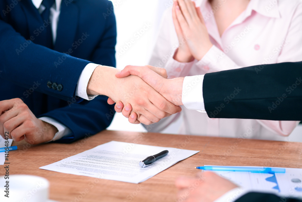 Business people shaking hands finishing up a meeting Business people shaking hands finishing up a meeting