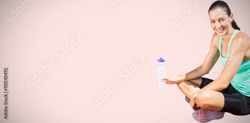 Composite image of portrait of happy sportswoman is sitting with
