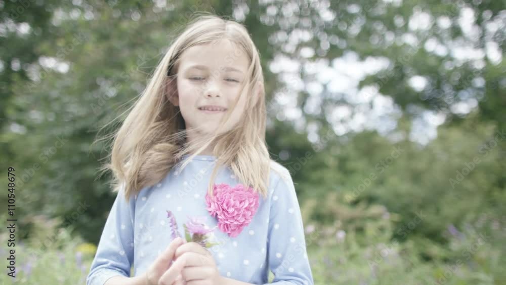 Portrait of pretty smiling little girl picking wildflowers outdoors Portrait of pretty smiling little girl picking wildflowers outdoors