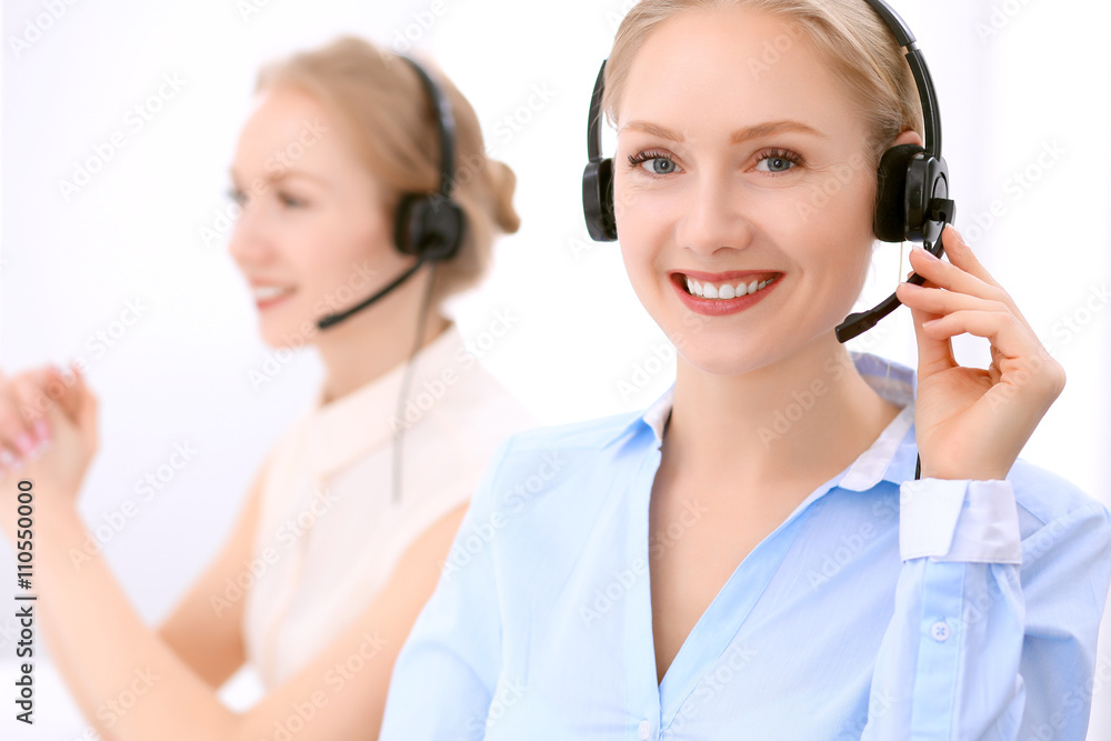 Call center. Focus on beautiful blonde woman in headset Call center. Focus on beautiful blonde woman in headset