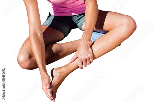Close up of sportswoman is hurting her foot 