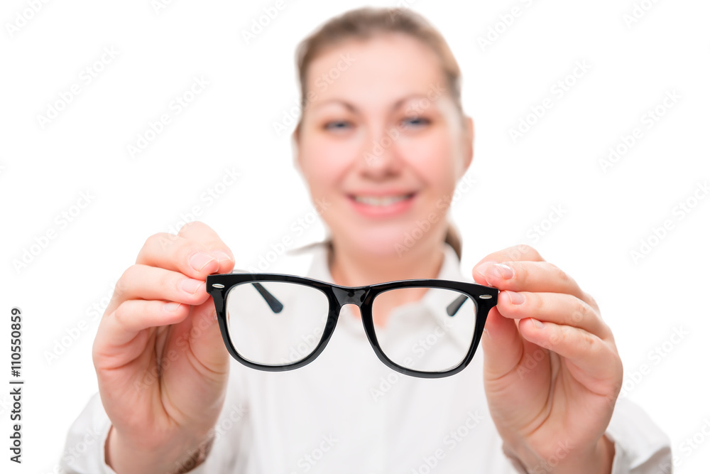 girl holding glasses, glasses in focus on a white background girl holding glasses, glasses in focus on a white background