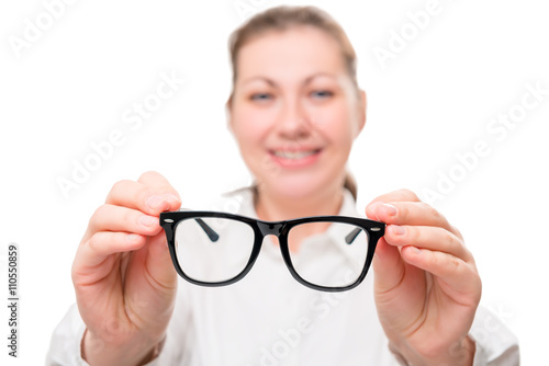 girl holding glasses  glasses in focus on a white background