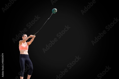 Portrait of sportswoman practising hammer throw 
