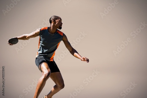 Schilderij op canvas Composite image of athlete man throwing a discus