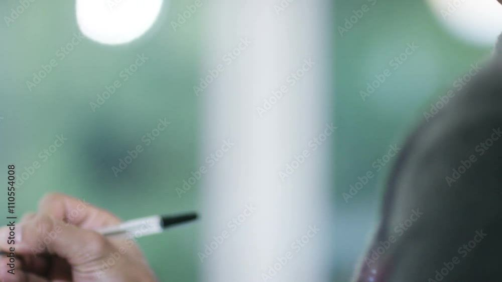 Close up portrait Asian man thinking and writing in a notebook Close up portrait Asian man thinking and writing in a notebook