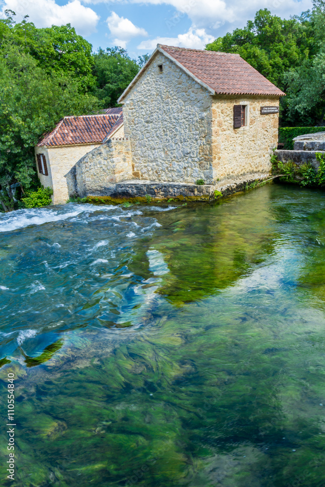 Krka national park, Croatia - May 05, 2016: historic buiding by rapids Krka national park, Croatia - May 05, 2016: historic buiding by rapids