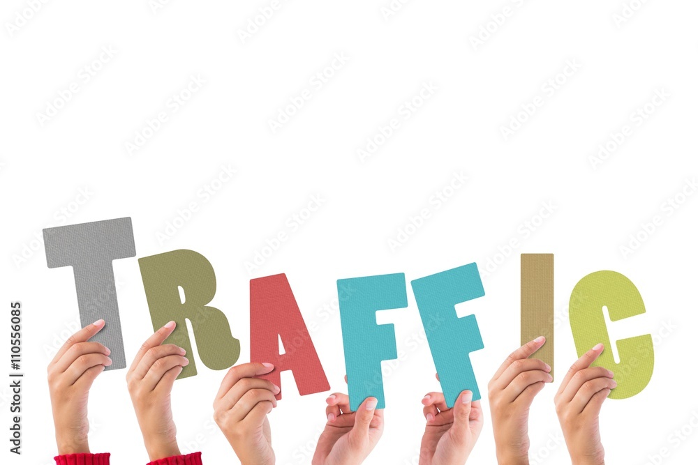Colorful alphabet spelling traffic held up by people Colorful alphabet spelling traffic held up by people