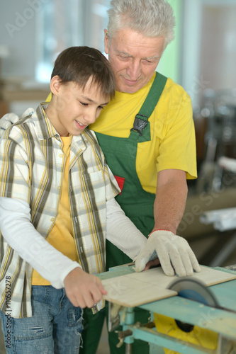 man and grandson repairing in the room