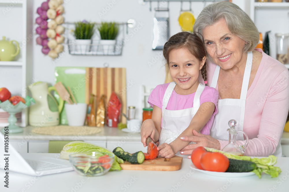 Senior woman with granddaughter cooking Senior woman with granddaughter cooking
