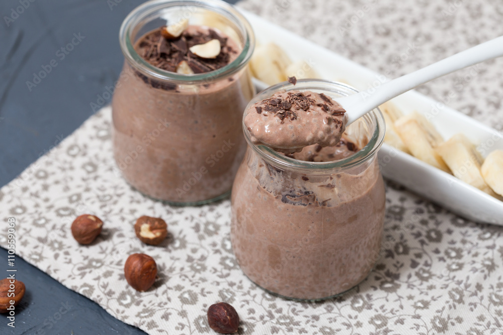 Chocolate pudding with chia seed, bananas and nuts, in a glass Chocolate pudding with chia seed, bananas and nuts, in a glass