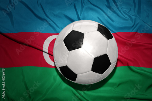 black and white football ball on the national flag of azerbaijan