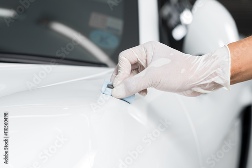 Car detailing series   Closeup of hand  coating white car paint