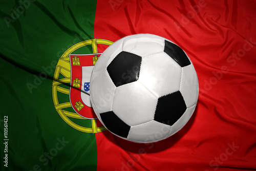 black and white football ball on the national flag of portugal