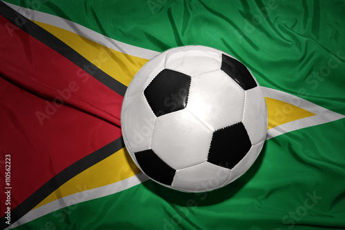 black and white football ball on the national flag of guyana