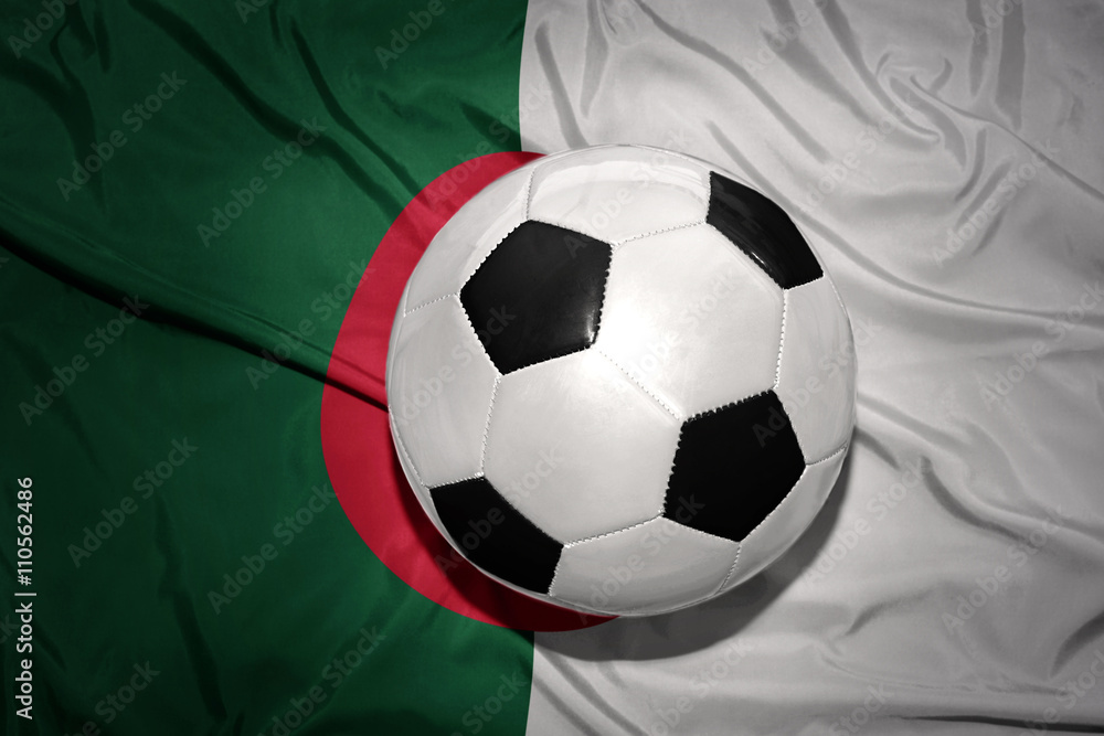 Fototapeta premium black and white football ball on the national flag of algeria