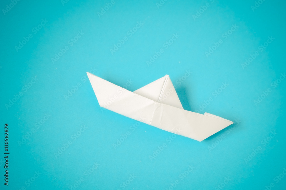 paper boat on blue background paper boat on blue background