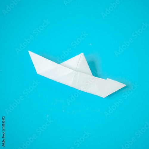 paper boat on blue background