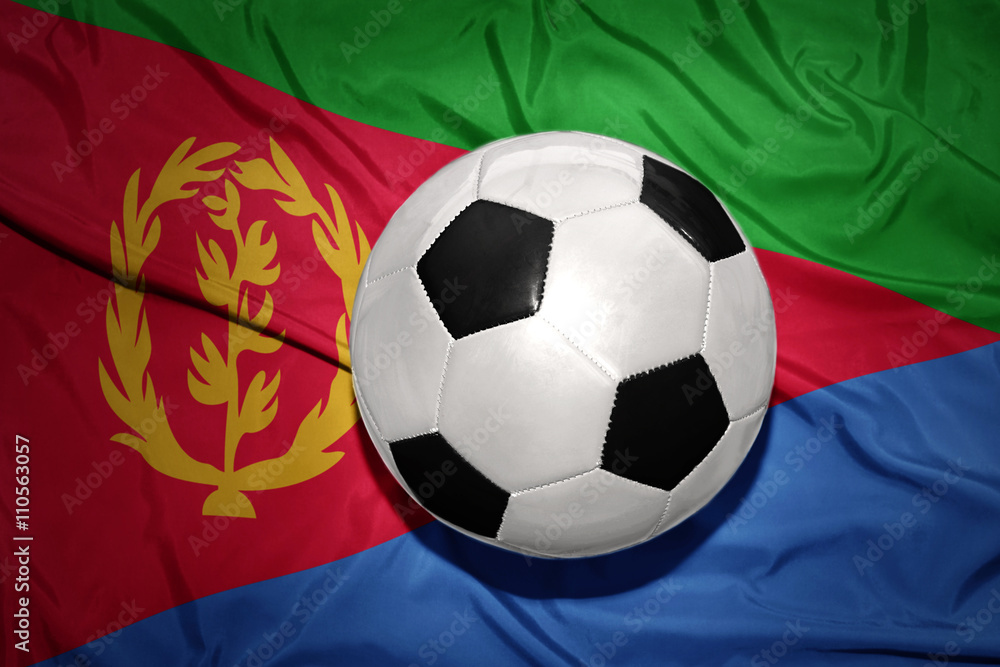 Fototapeta premium black and white football ball on the national flag of eritrea