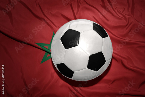 black and white football ball on the national flag of morocco