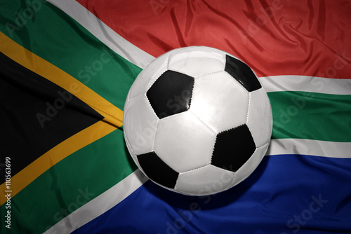 black and white football ball on the national flag of south africa