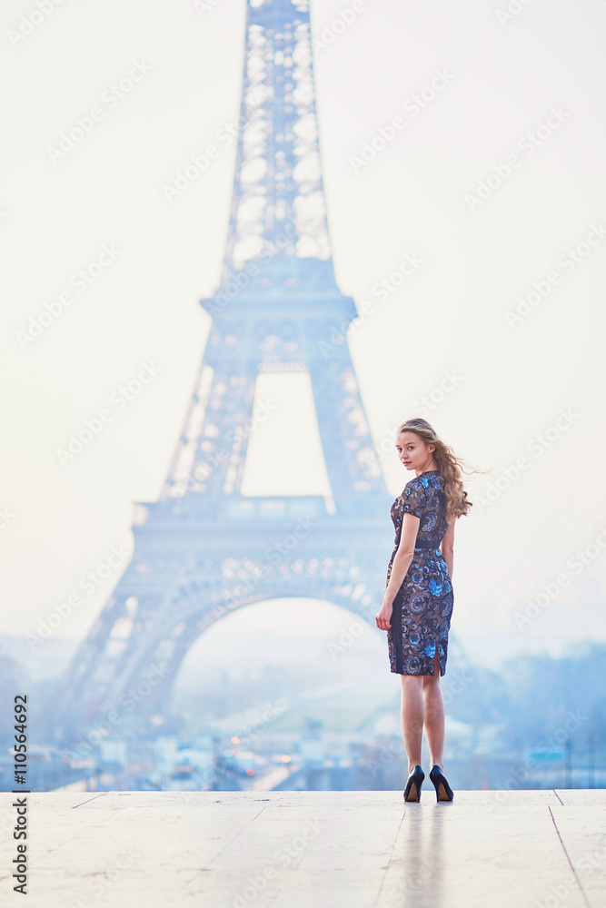 Parisian woman near the Eiffel tower at morning