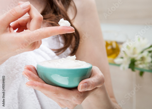 Woman holding a bowl with nourishing mask