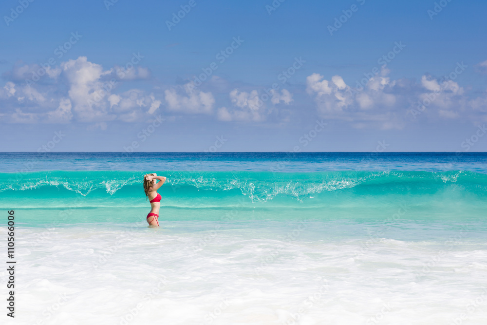 Beautiful and sexy blonde woman in red bikini, turquise sea